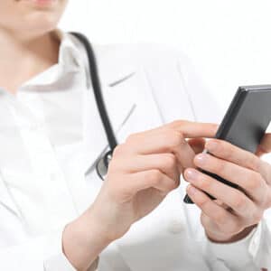 doctor inputting data on phone