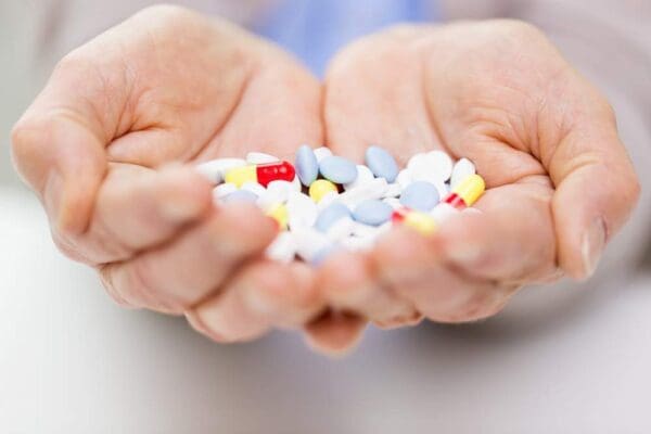 pile of pills in hands
