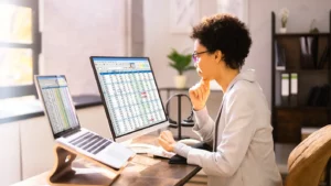 a female clinician reviewing ICD-10 coding on her computer