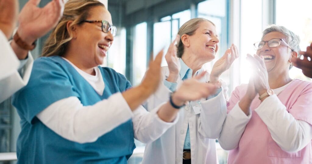 a group of nurses and doctors applauding