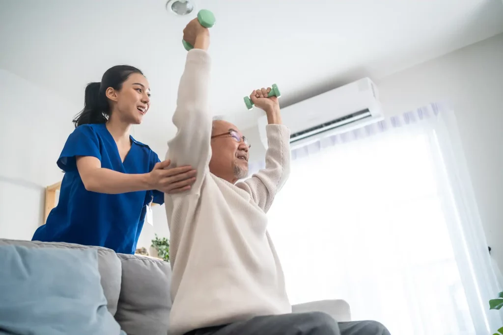 an at home nurse working out with her elderly patient