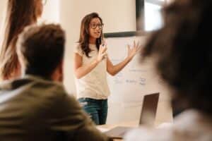 a female home health professional presenting information to a group of people