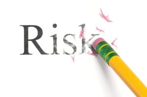a pencil erasing the word "risk"