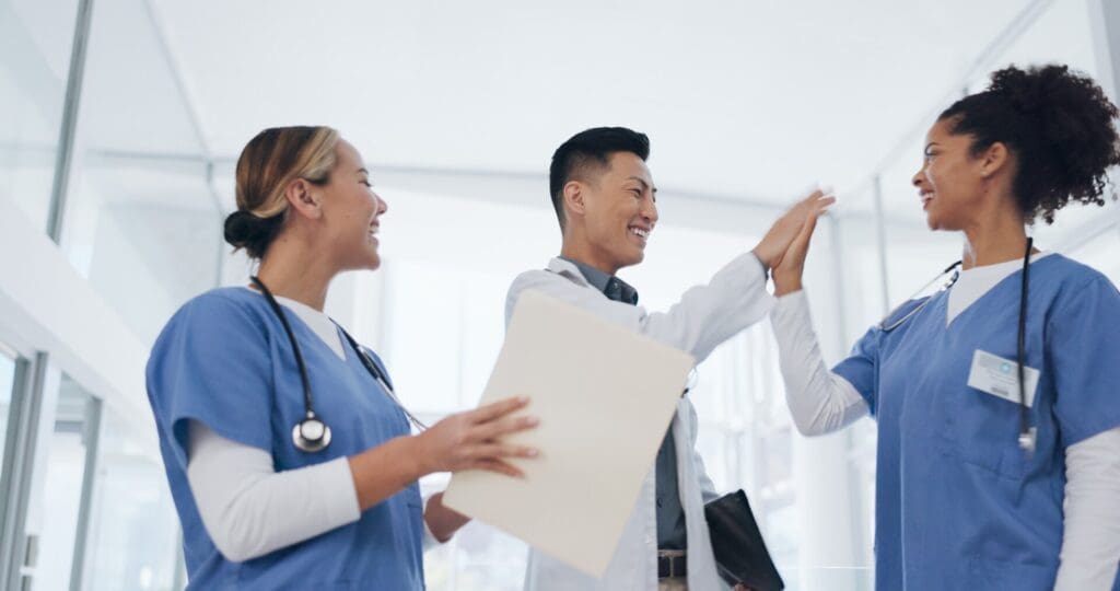 a group of clinicians high fiving