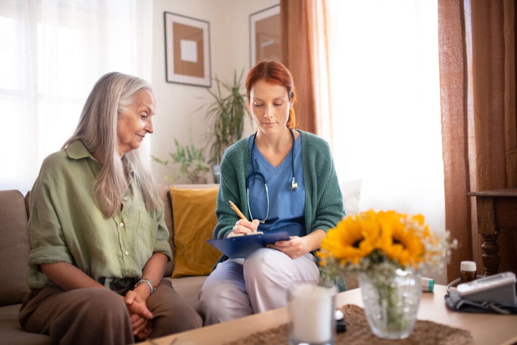 Home health aide helping female patient
